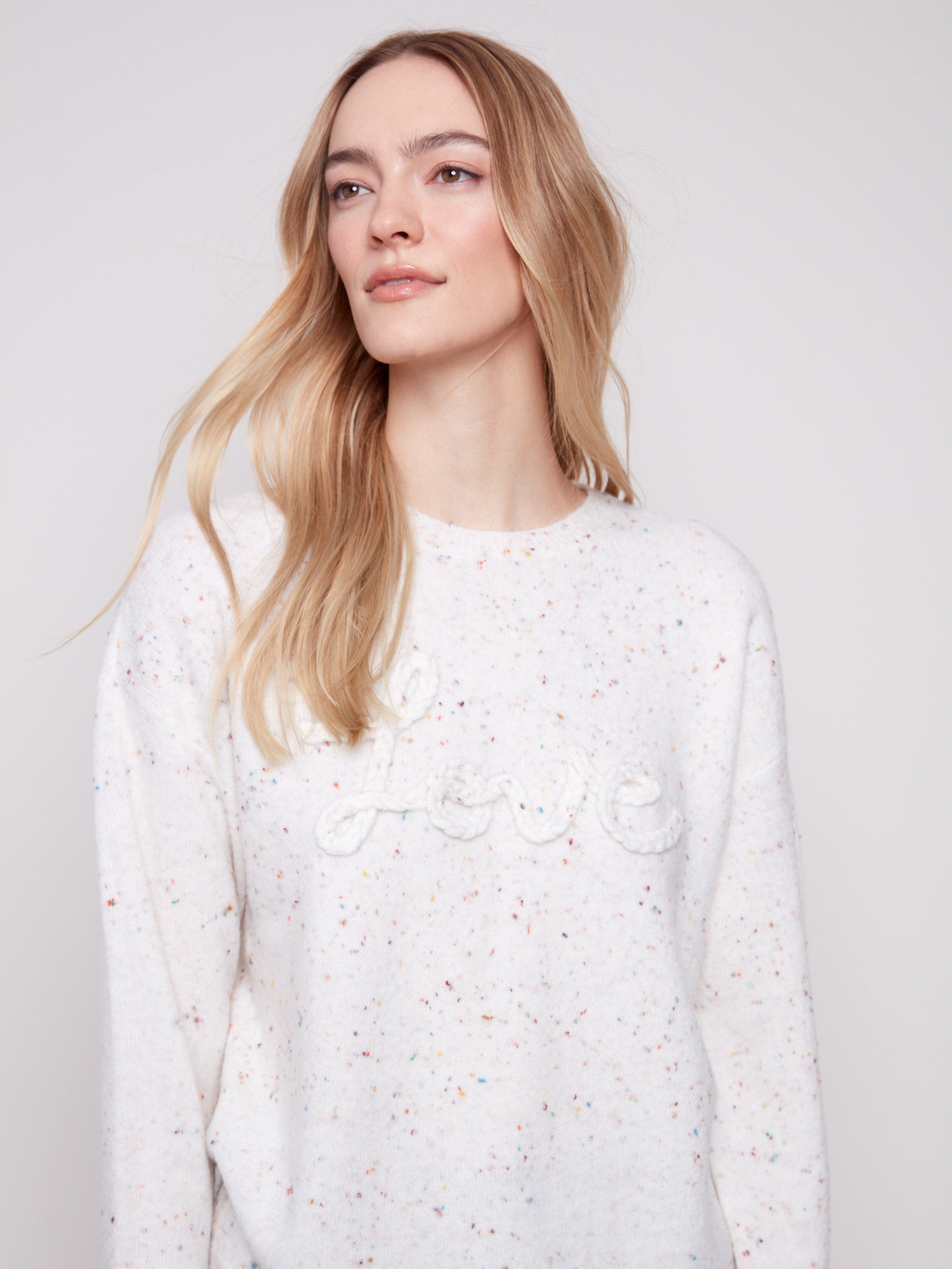 Elegant ecru sweater showcasing a charming speckled pattern and drop shoulder design for a relaxed fit by Charlie B.