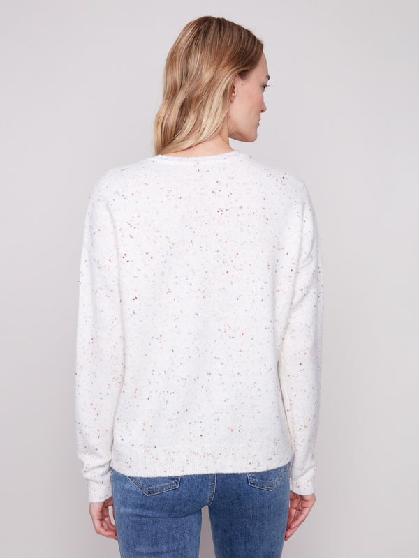 Ecru sweater with a lovely drop shoulder design, adorned with colorful speckles for added charm by Charlie B.