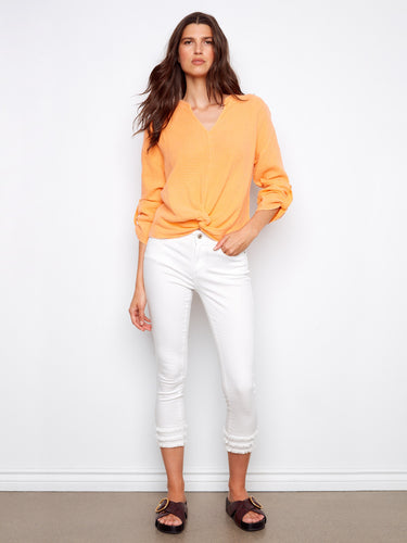 Featuring long roll-up sleeves, this orange top offers versatility and style. Crafted from 100% cotton for all-day wear by Charlie B.