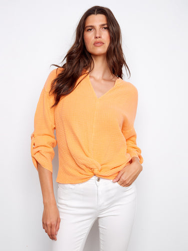 Elevate your wardrobe with this trendy orange top featuring roll-up sleeves and a relaxed fit in pure cotton for easy elegance by Charlie B.