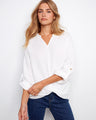 White blouse with long roll-up sleeves and a front knot, crafted from 100% cotton for comfort and style by Charlie B.