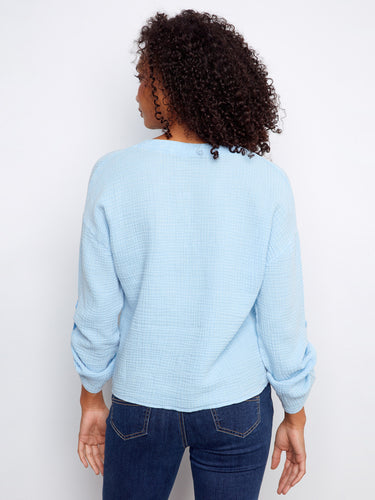 Casual light blue shirt showcasing a unique front knot and notch neckline, made from breathable 100% cotton by Charlie B.