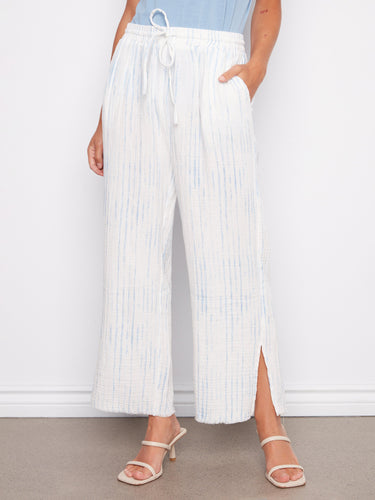 Cropped bubble cotton pants in white and blue stripes, designed with an elastic waist and drawstring by Charlie B.