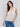 Elegant sleeveless design in a natural tone by Charlie B.