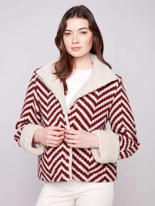 Chevron-patterned jacket with button closure, offering a blend of style and warmth in bouclé fabric by Charlie B.