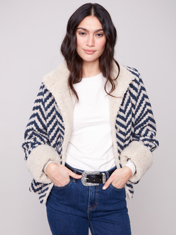 Navy Chevron Boucle Jacket showcasing faux sherpa trim on collar and cuffs for added warmth by Charlie B.