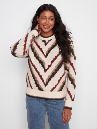 Cozy sweater with a crew neck design, featuring a striking chevron pattern in warm tones. Perfect for layering. By Charlie B.
