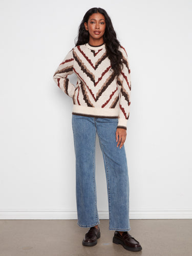 Stylish long-sleeve sweater with intricate chevron detailing, perfect for casual outings or cozy days at home. By Charlie B.