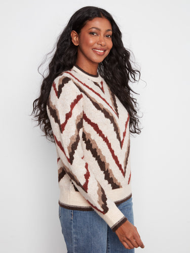 Elegant sweater showcasing ribbed cuffs and hem, offering both comfort and style in a timeless design. By Charlie B.