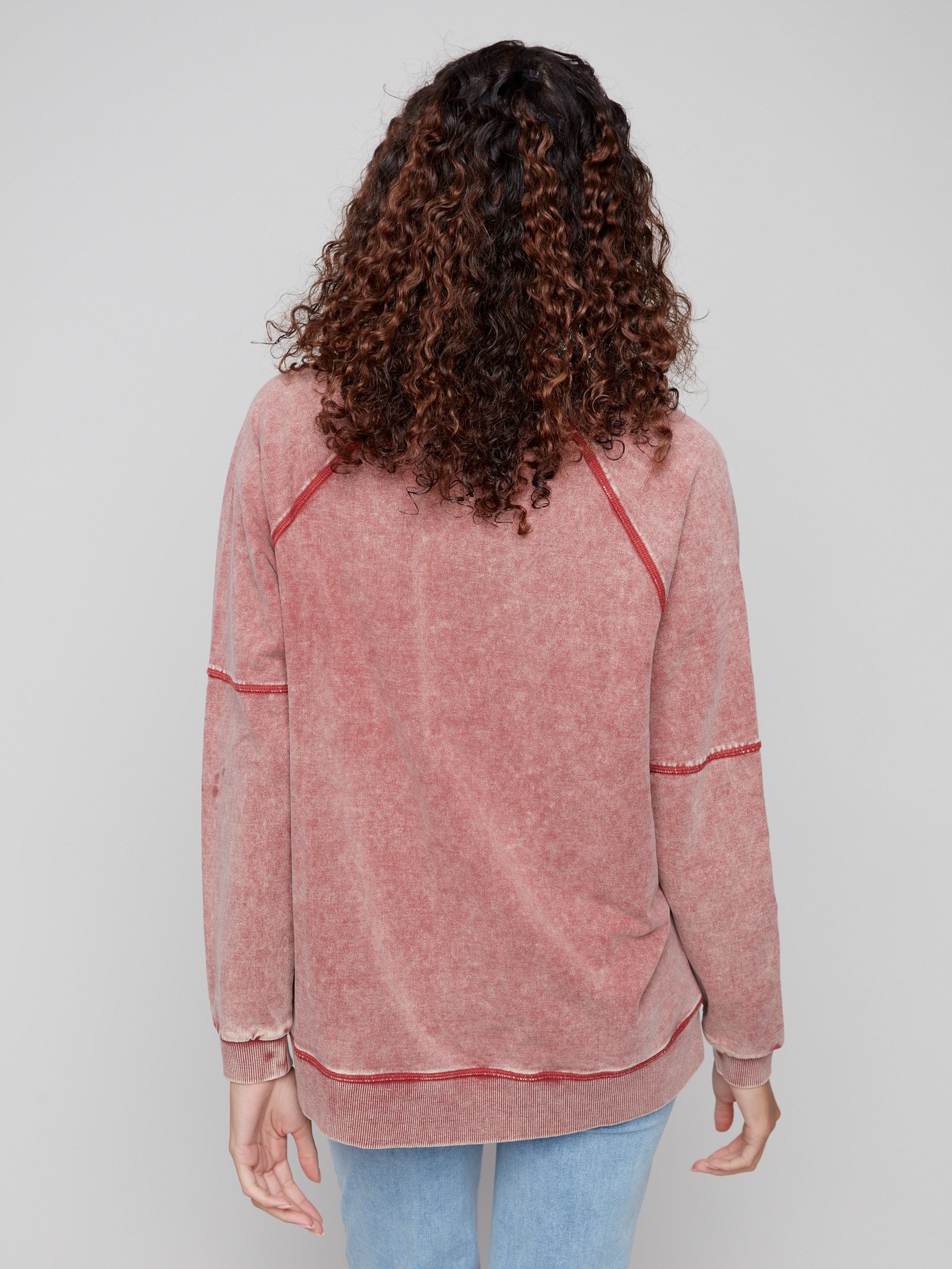 Side slits provide extra comfort and flexibility in this Cabernet casual top by Charlie B.