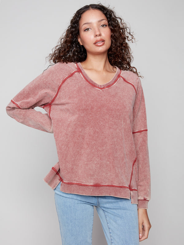 This stylish Cabernet V-neck showcases a relaxed fit with an eye-catching design element by Charlie B.