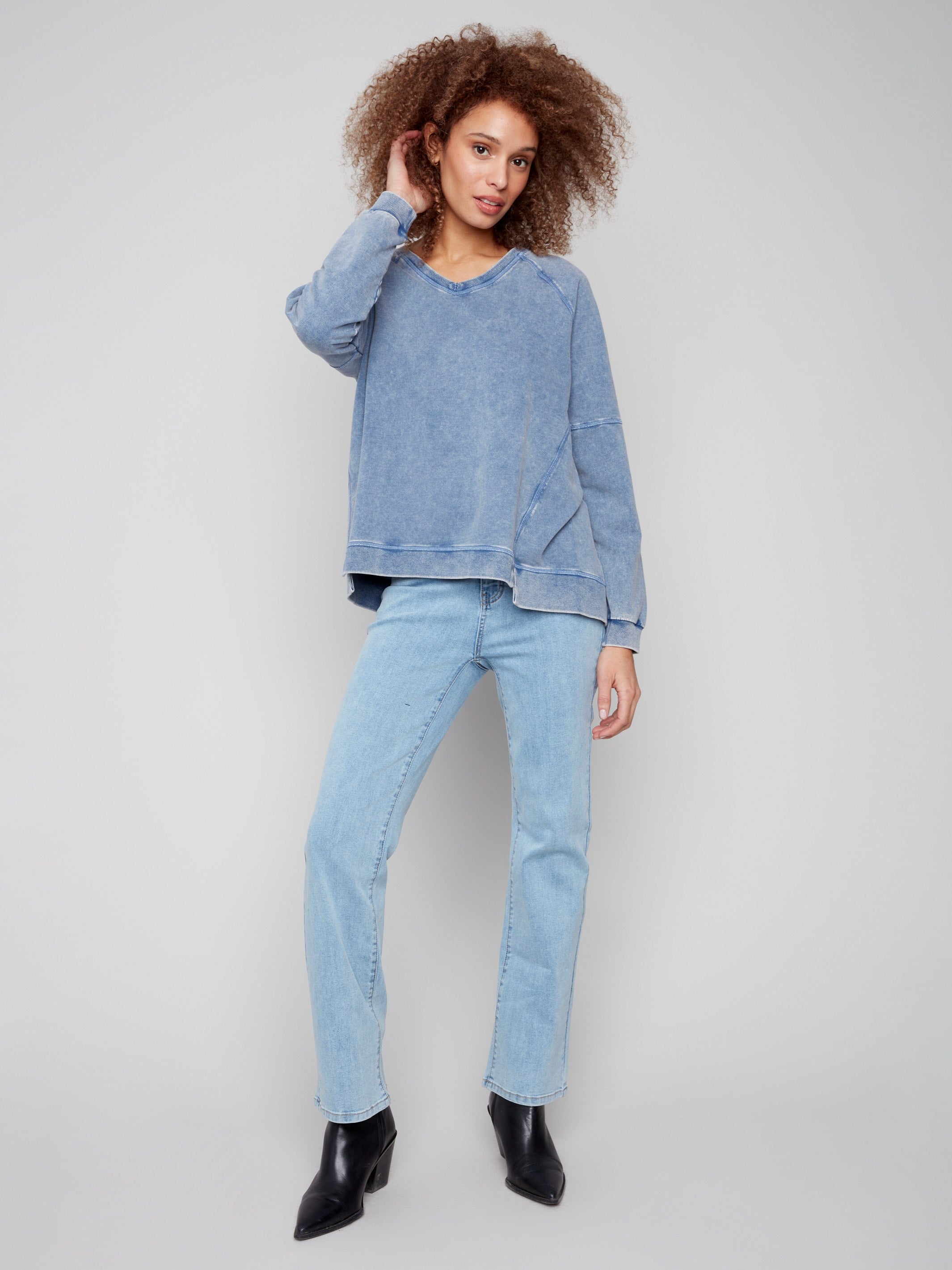 Denim V-neck top featuring a washed effect, adding a touch of vintage charm to the ensemble by Charlie B.