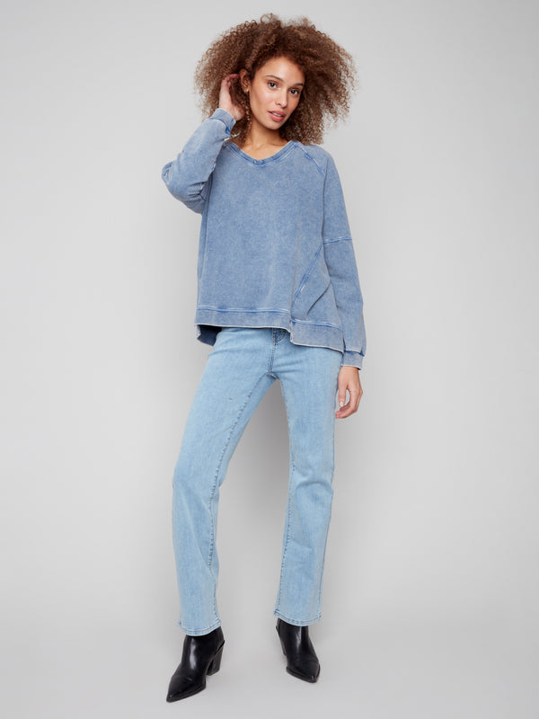 Denim V-neck top featuring a washed effect, adding a touch of vintage charm to the ensemble by Charlie B.