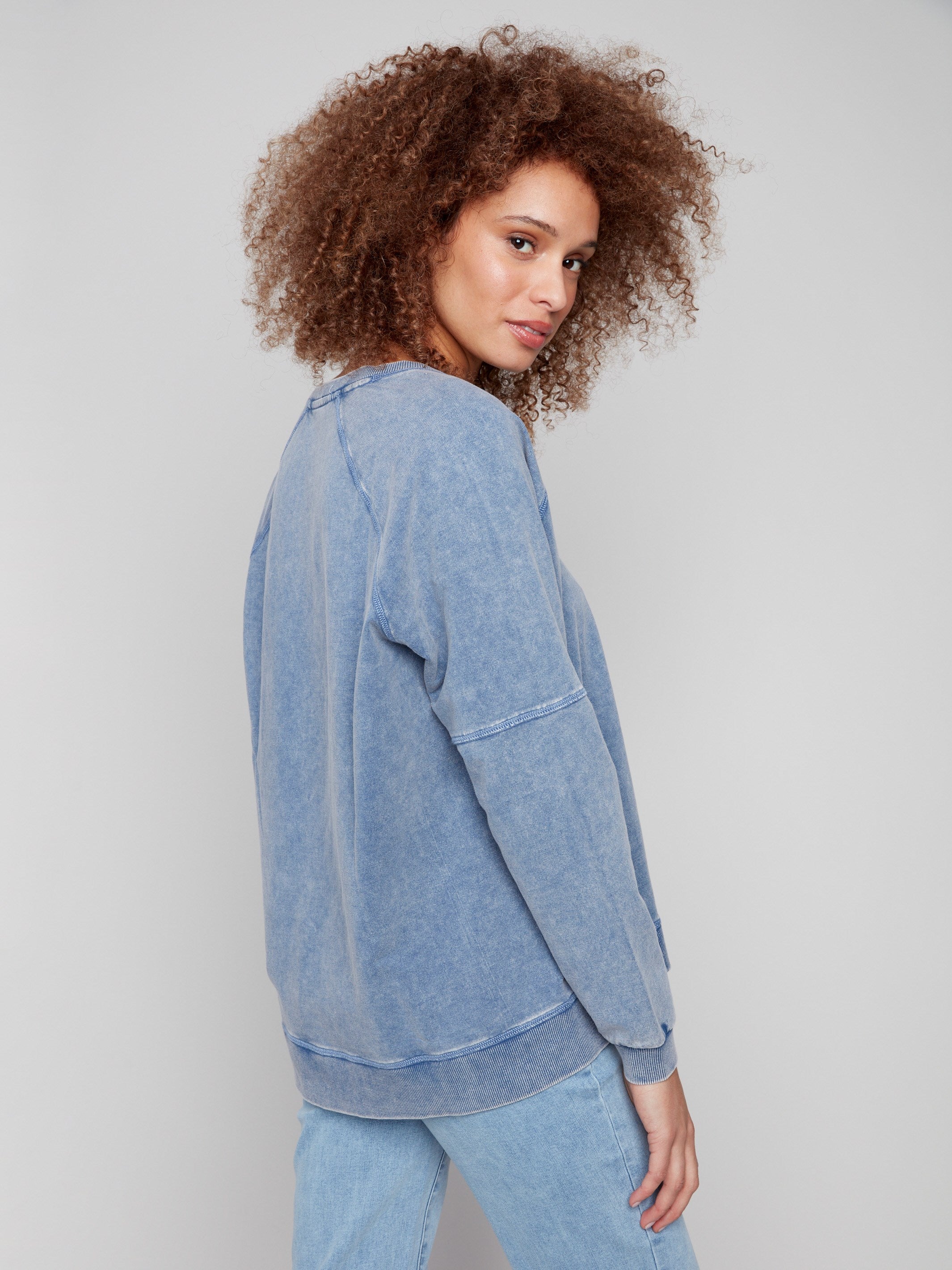 Denim V-neck top with stylish side slits, enhancing movement and comfort for everyday wear by Charlie B.