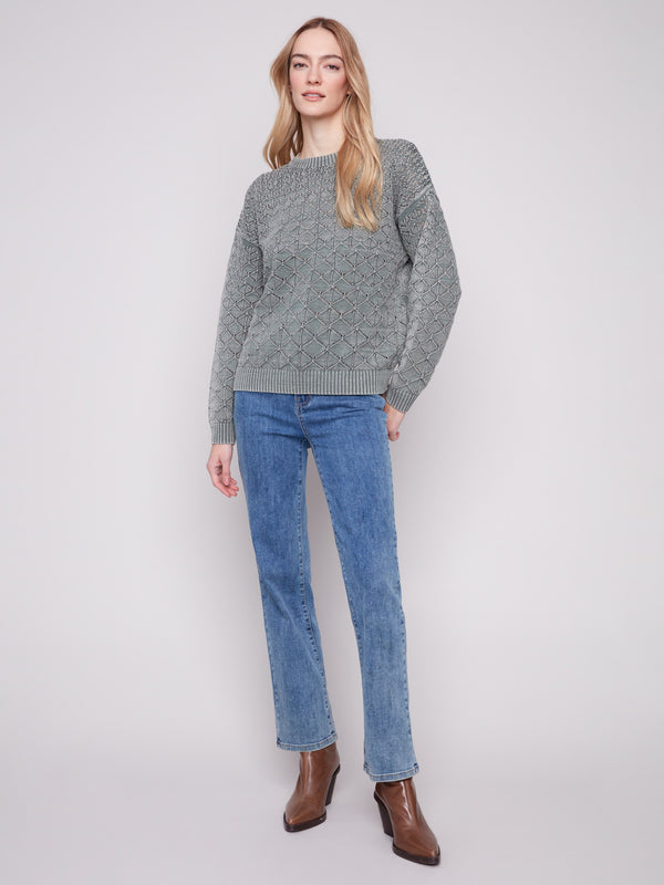 The drop shoulders on the spruce pointelle sweater offer a contemporary twist to this timeless piece by Charlie B.