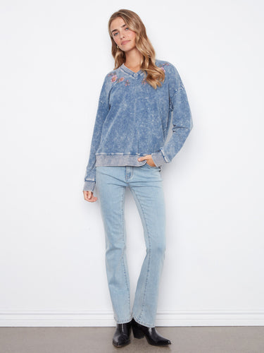 Stretch cotton denim blue top with V-neck and charming embroidered flowers for an elegant touch by Charlie B.