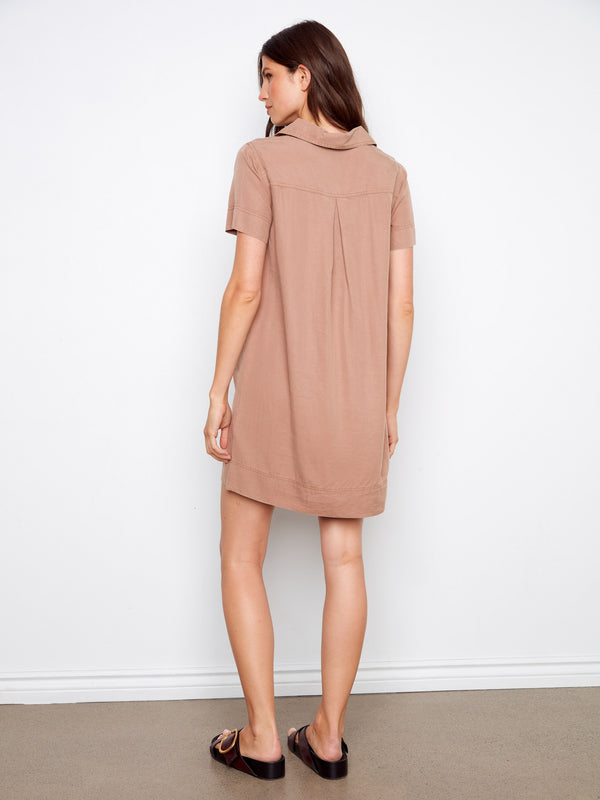 Featuring practical patch pockets, this versatile knee-length dress combines style and functionality effortlessly by Charlie B.