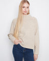 Beige sweater featuring a mock neck and folded cuffs, perfect for cozy days. Styled with long raglan sleeves by Charlie B.