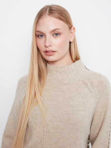 Classic beige knitwear designed with attention to detail, including folded cuffs and contrast stitching by Charlie B.