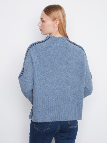 Soft blue sweater highlighting long raglan sleeves for added comfort and style in cooler weather by Charlie B.