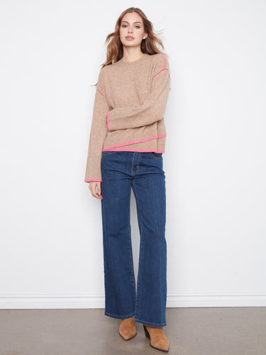 Enjoy the asymmetrical hem on this sweater, adding an unexpected twist to its classic design. By Charlie B.