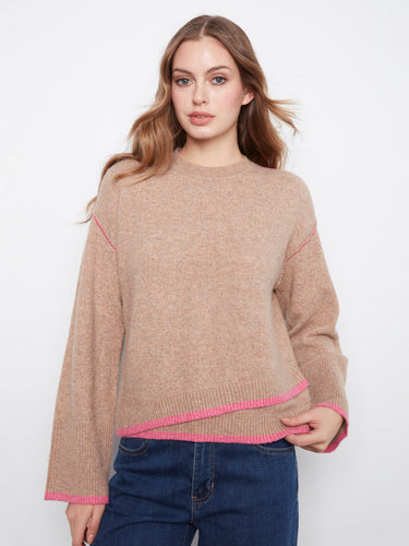 The contrast trim adds a pop of color to this sweater, enhancing its modern appeal. By Charlie B.