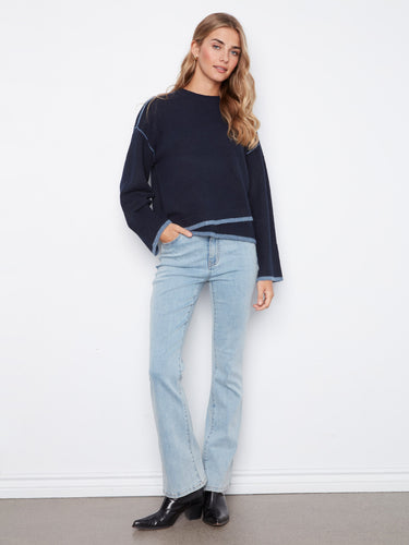 Featuring an asymmetrical hem, this sweater adds a touch of modern flair to your outfit. Perfectly styled with boots by Charlie B.