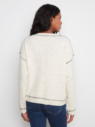 This chic sweater showcases intricate whipstitch detailing along the edges for added style by Charlie B.