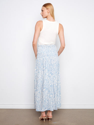 Versatile floral garment in light blue, highlighting removable straps and adaptability for different styles by Charlie B.