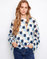 Floral crochet top in a cotton blend featuring a stylish boat neckline. Perfect for casual outings or layering. By Charlie B.