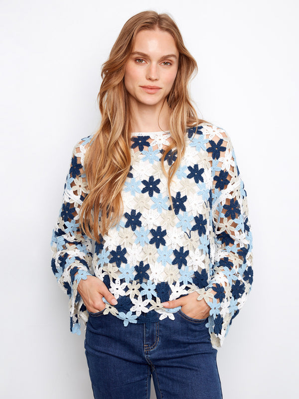 Floral crochet top in a cotton blend featuring a stylish boat neckline. Perfect for casual outings or layering. By Charlie B.