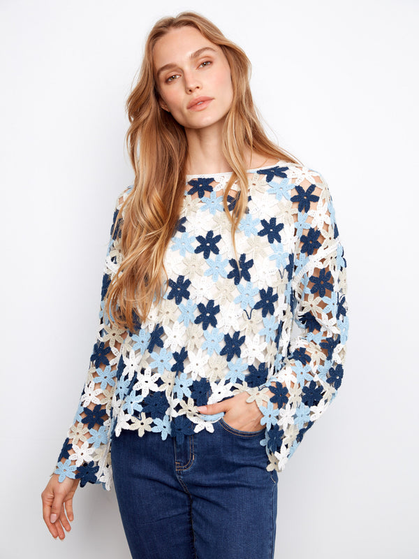 Charming floral crochet top with drop shoulders, offering a relaxed fit and easy movement. Ideal for any season. By Charlie B.