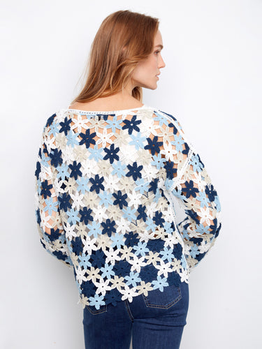 Floral crochet top featuring drop shoulders, creating an effortlessly chic look that's both versatile and fashionable. By Charlie B.
