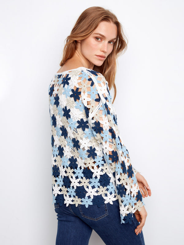 Chic floral crochet top with 3/4 sleeves made from cotton blend fabric, offering comfort and style in one piece. By Charlie B.