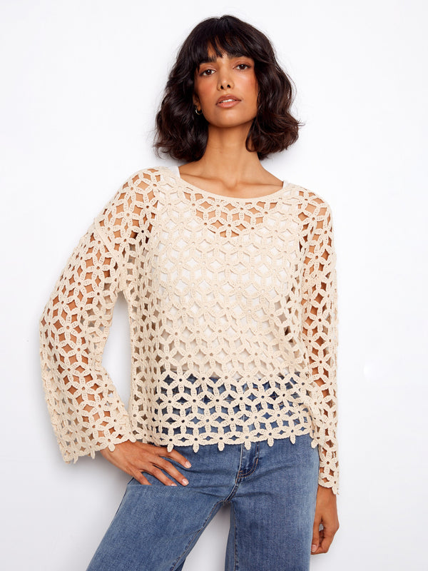 Elegant crochet top with a boat neckline, showcasing intricate patterns and a relaxed fit. Perfect for any occasion by Charlie B.