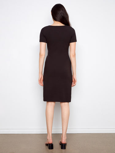 Chic black dress showcasing unique design elements like the waist tie and cuffed sleeves for added flair by Charlie B.