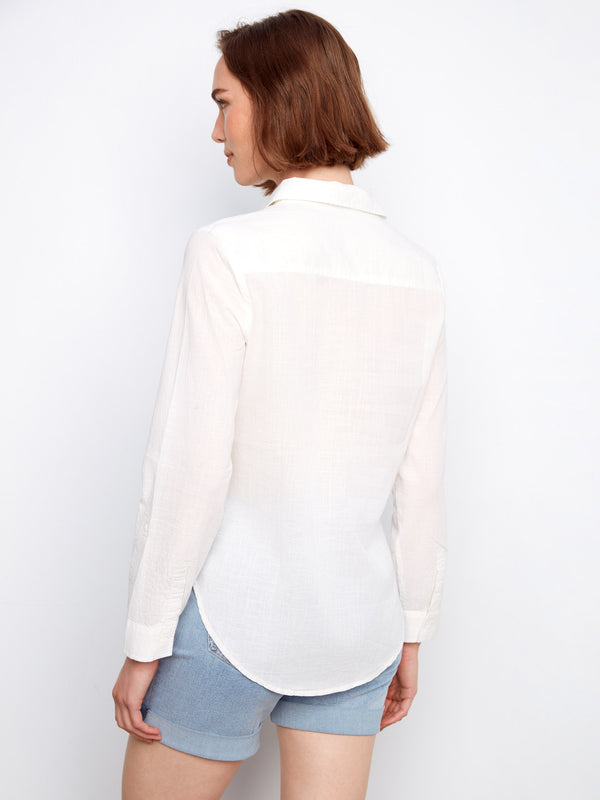 Fashionable white button-up shirt offering timeless appeal and breathable cotton construction by Charlie B.