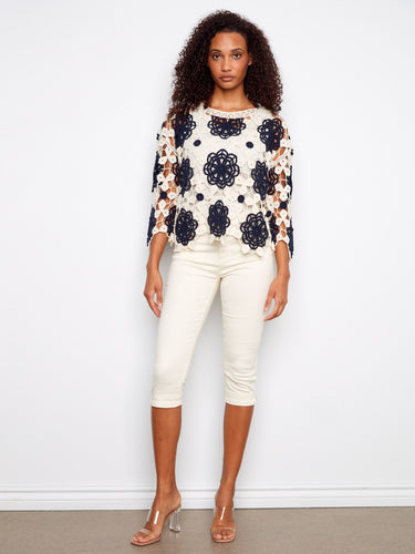 Chic crochet top showcasing a floral design and stylish boat neckline by Charlie B.