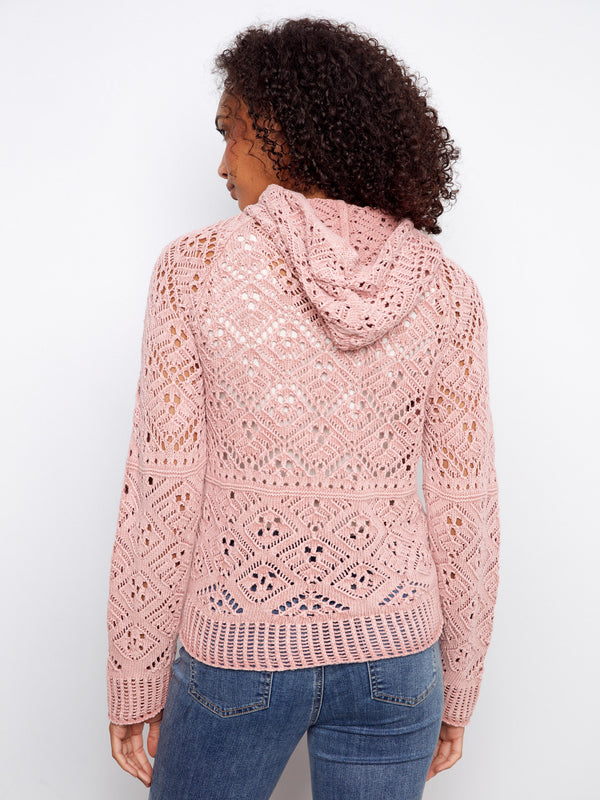 Charming pink crochet sweater made of 100% cotton, highlighting its breathable fabric and unique design elements by Charlie B.