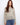 The sweater features a hooded design, adding a cozy touch to its intricate knit pattern. Perfect for casual outings. By Charlie B.
