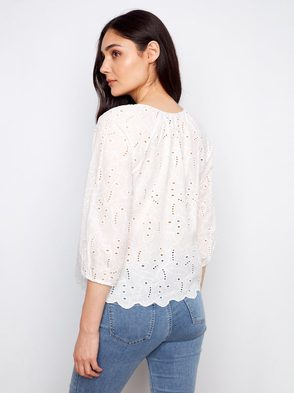 Stylish white cotton blouse highlighted by a notched neckline tied elegantly, complete with 3/4 sleeves by Charlie B.
