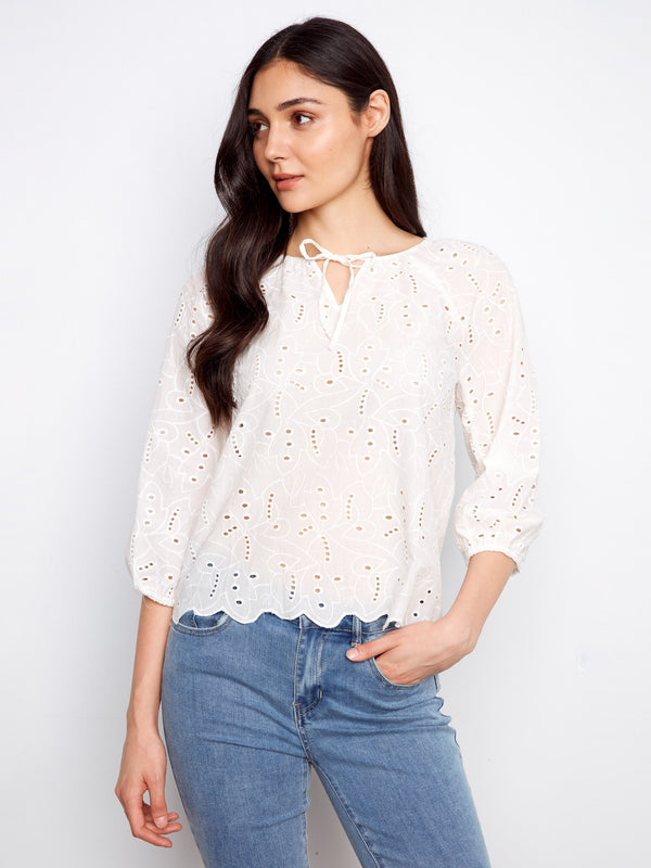 Sophisticated white blouse designed with elastic cuffs on the 3/4 sleeves and charming eyelet accents by Charlie B.