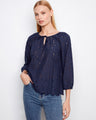 Blouse with a notched neckline and tie, featuring intricate eyelet detailing for a chic look by Charlie B.