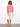 This coral top showcases intricate eyelet detailing, perfect for a breezy and stylish look by Charlie B.