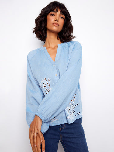 Fashionable blouse featuring a button-front closure paired with exquisite eyelet details for an elegant look by Charlie B.