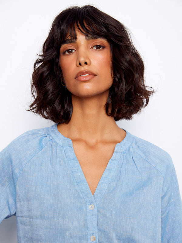 The subtle texture of the fabric complements the overall design of this chic blouse, offering both style and comfort by Charlie B.