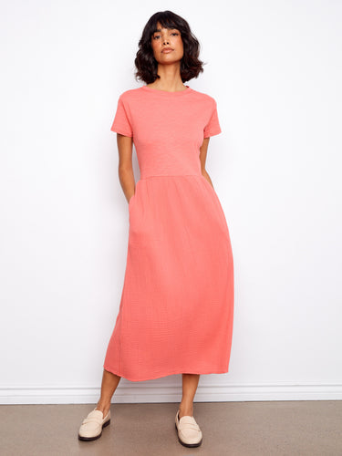 Designed with short sleeves, this dress provides comfort and style for warm weather outings by Charlie B.
