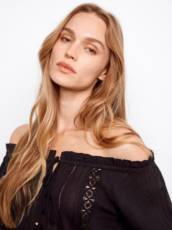 Cotton blouse in black with intricate openwork trim and elastic cuffs by Charlie B.