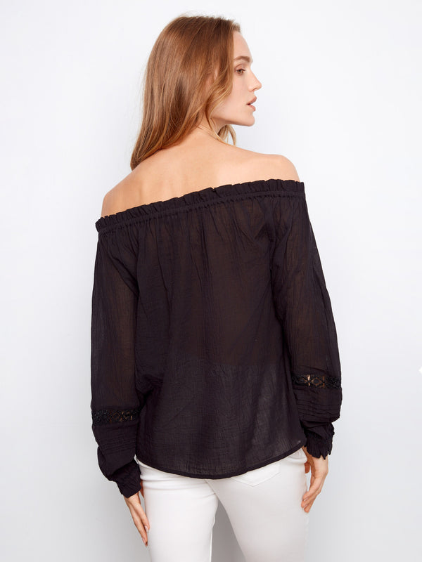 Elegant off-the-shoulder black blouse in semi-sheer cotton fabric by Charlie B.