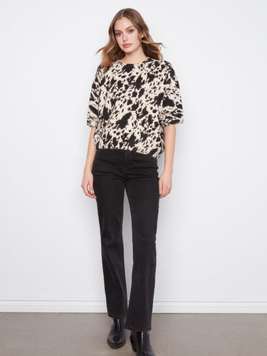 Stylish mock neck with unique pattern makes this piece a standout addition to your wardrobe. By Charlie B.